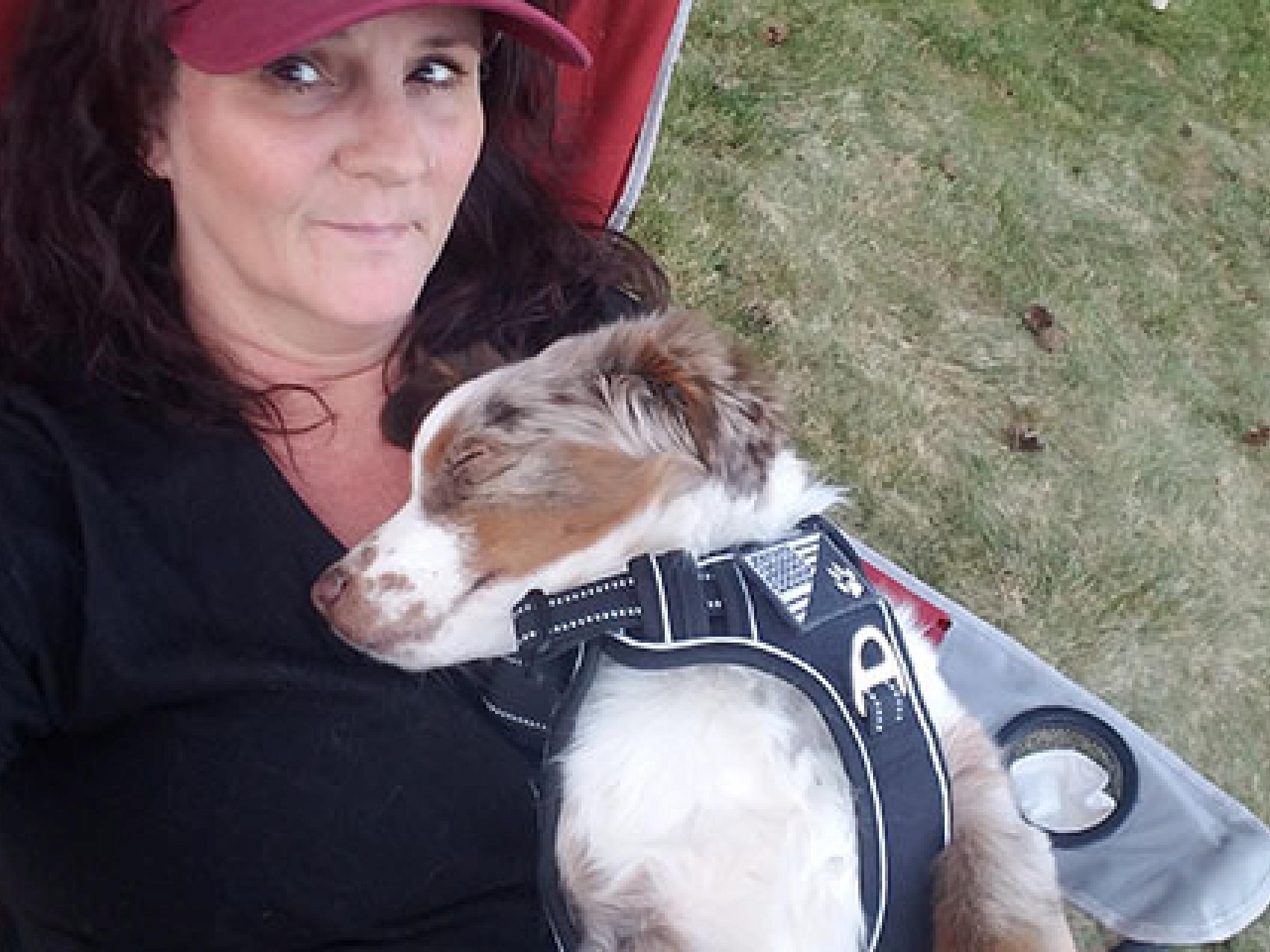 Kelly Carnahan, spine pain patient, with her dog asleep on her chest
