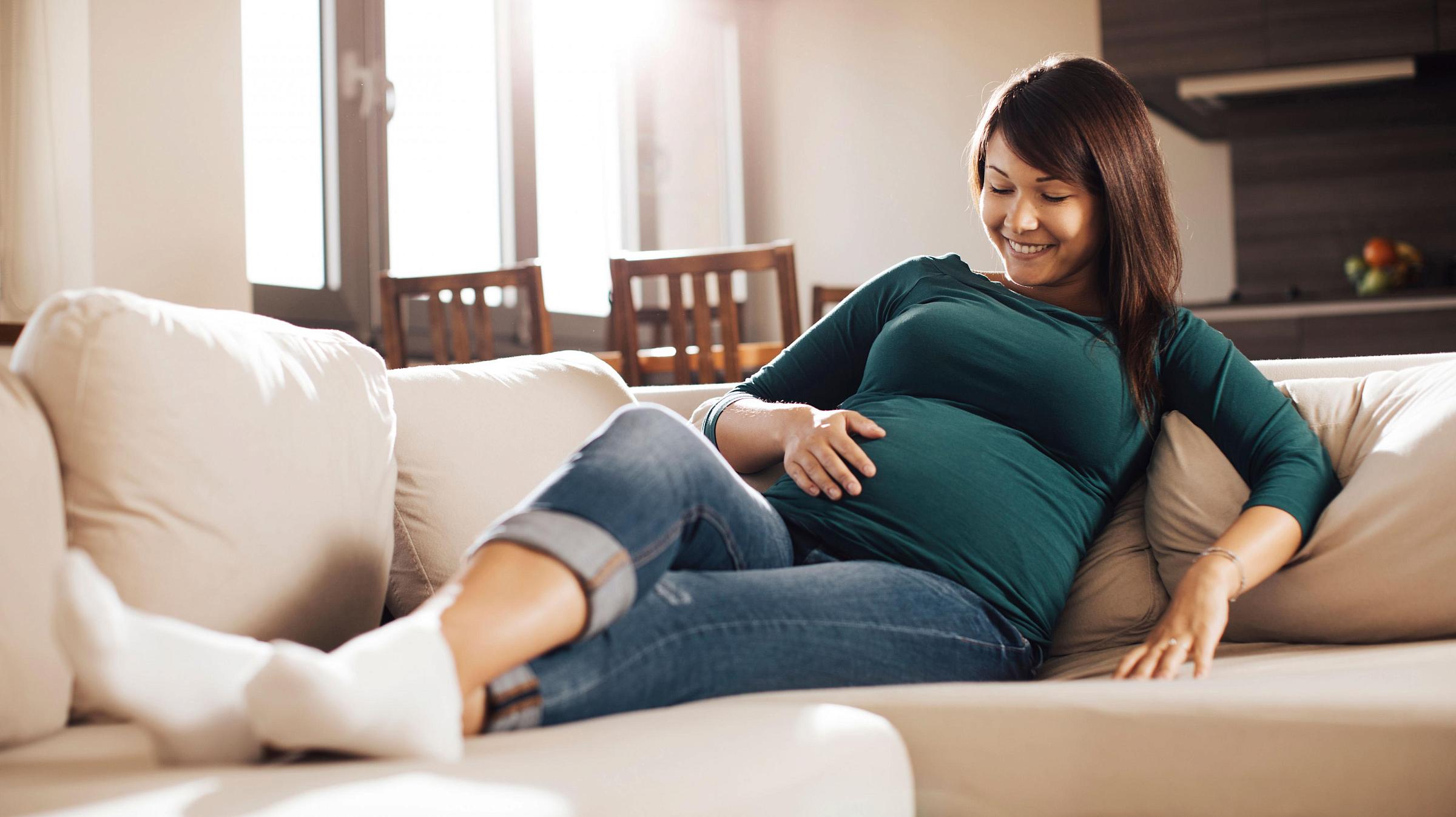 Mother looking at her pregnant stomach